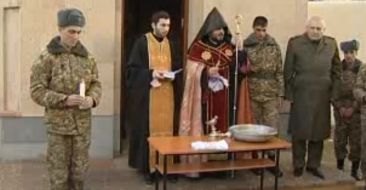 A soldier was baptised by the Primate of Chaplains